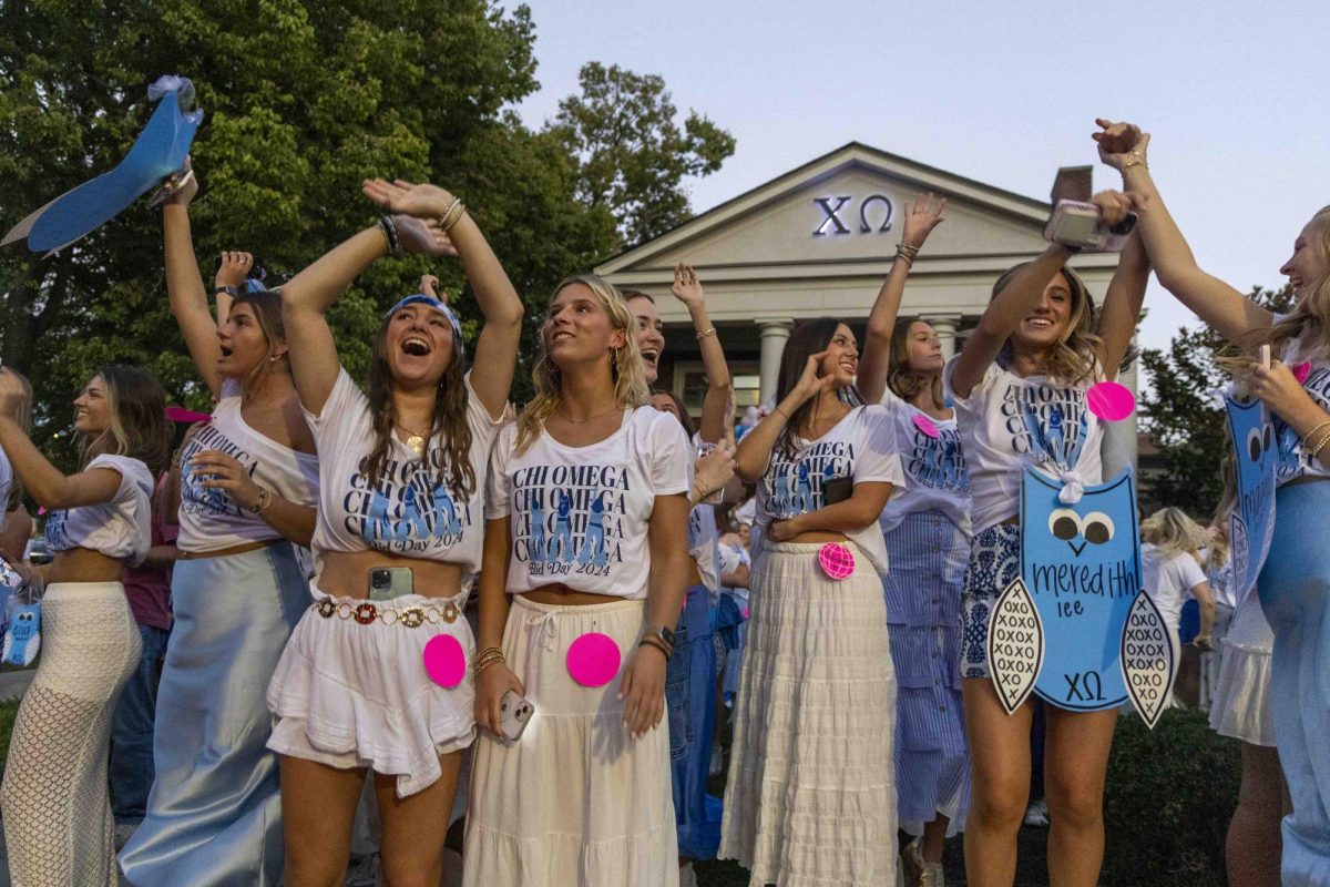 Members of Chi Omega cheer as new members ride by in buses during bid day on Monday, Sept. 9, 2024, at Greek Row in Lexington, Kentucky. Photo by Matthew Mueller | Staff