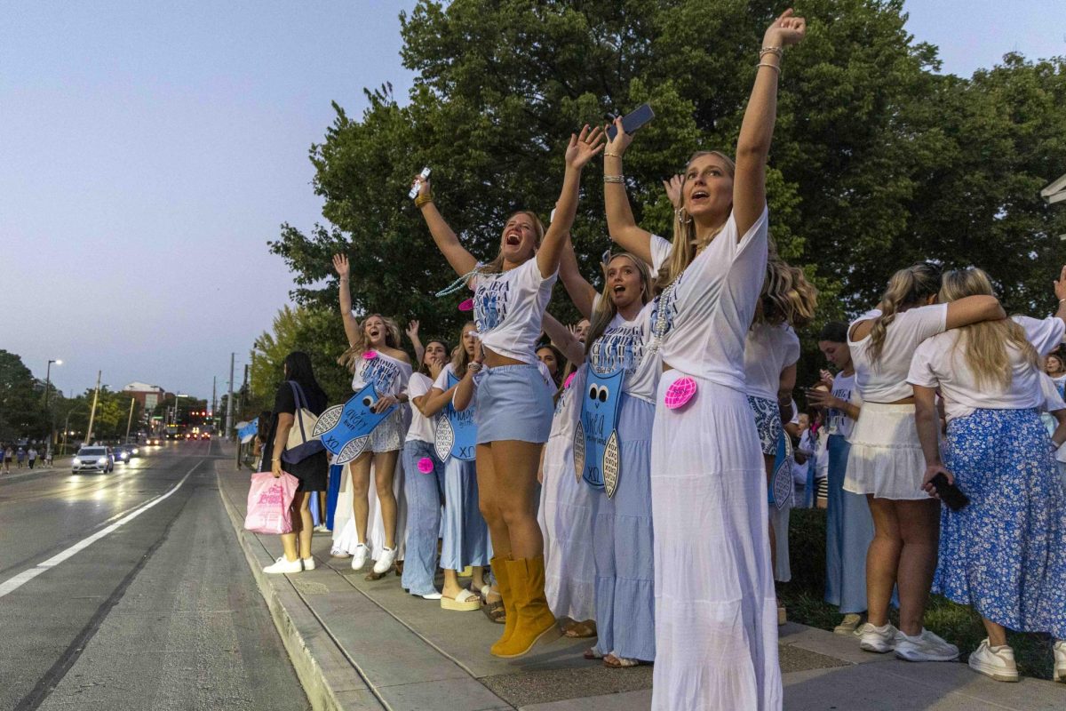 Members of Chi Omega cheer as new members ride by in buses during bid day on Monday, Sept. 9, 2024, at Greek Row in Lexington, Kentucky. Photo by Matthew Mueller | Staff