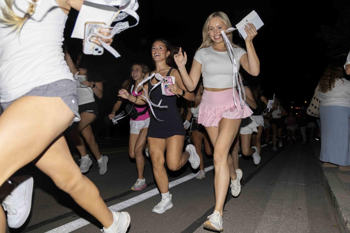 New sorority members run to their new houses during bid day on Monday, Sept. 9, 2024, at Greek Row in Lexington, Kentucky. Photo by Matthew Mueller | Staff