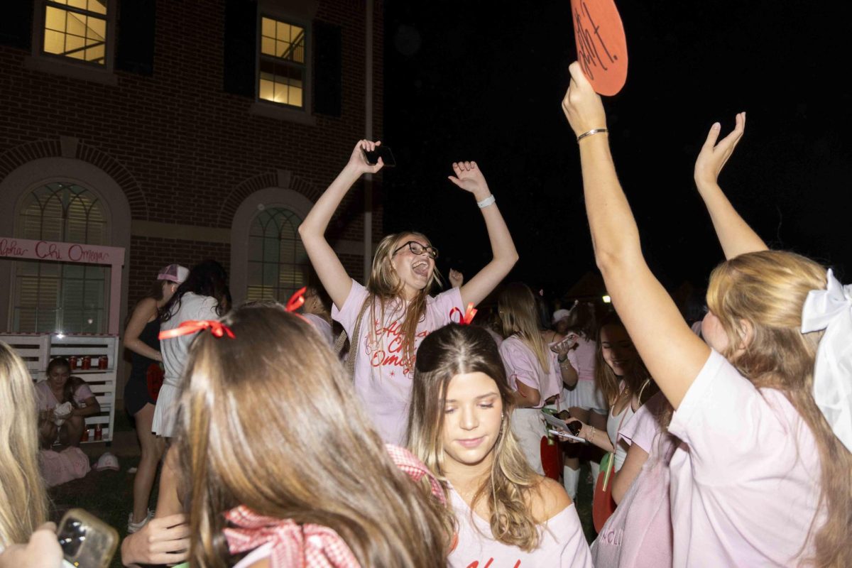 Members of Alpha Chi Omega cheer after new members arrive at their house during bid day on Monday, Sept. 9, 2024, at Greek Row in Lexington, Kentucky. Photo by Matthew Mueller | Staff