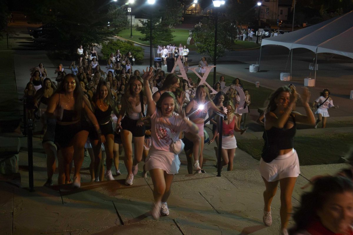 Incoming Alpha Chi Omega Members run towards their new house during Sorority Bid Day oon Monday, Sept. 9, 2024, at Greek Row in Lexington, Kentucky. at Greek Row in Lexington, Kentucky. Photo by Sydney Novack | staff