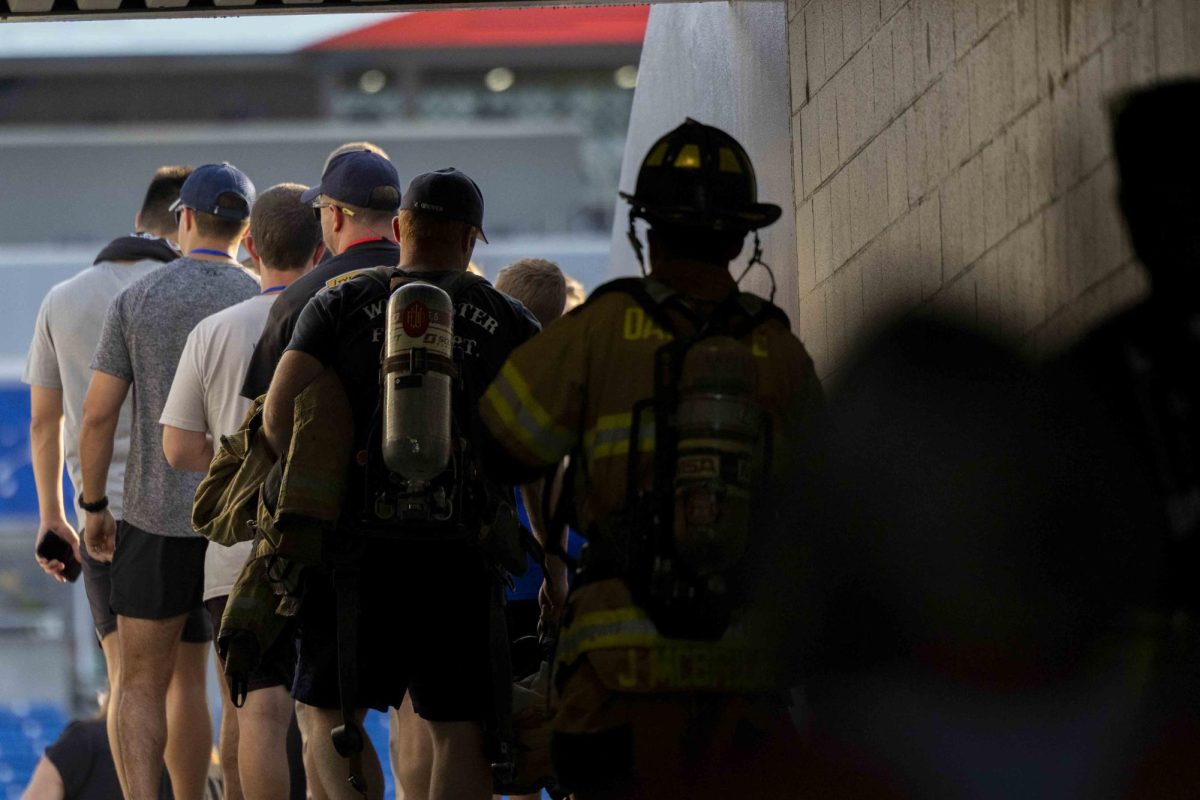 Participants walk out to the stand before the start of the 9/11 Memorial Stair Climb on Wednesday, Sept. 11, 2024, at Kroger Field in Lexington, Kentucky. Photo by Matthew Mueller | Staff