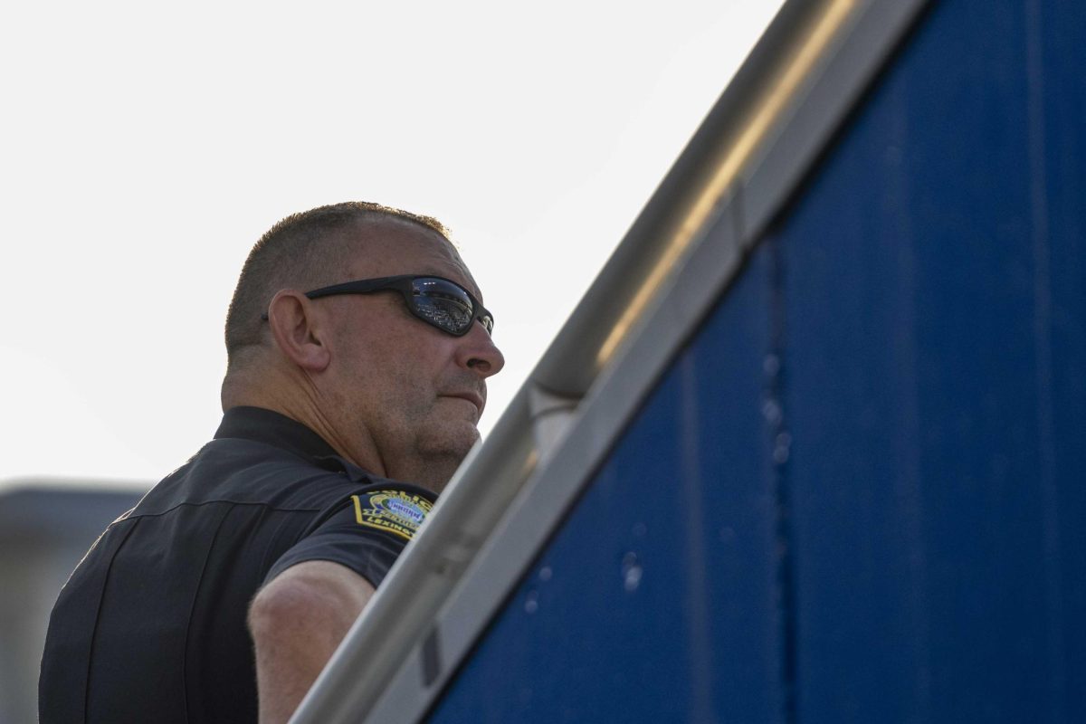 A police officer stands looking over the crowd of people during the 9/11 Memorial Stair Climb on Wednesday, Sept. 11, 2024, at Kroger Field in Lexington, Kentucky. Photo by Matthew Mueller | Staff