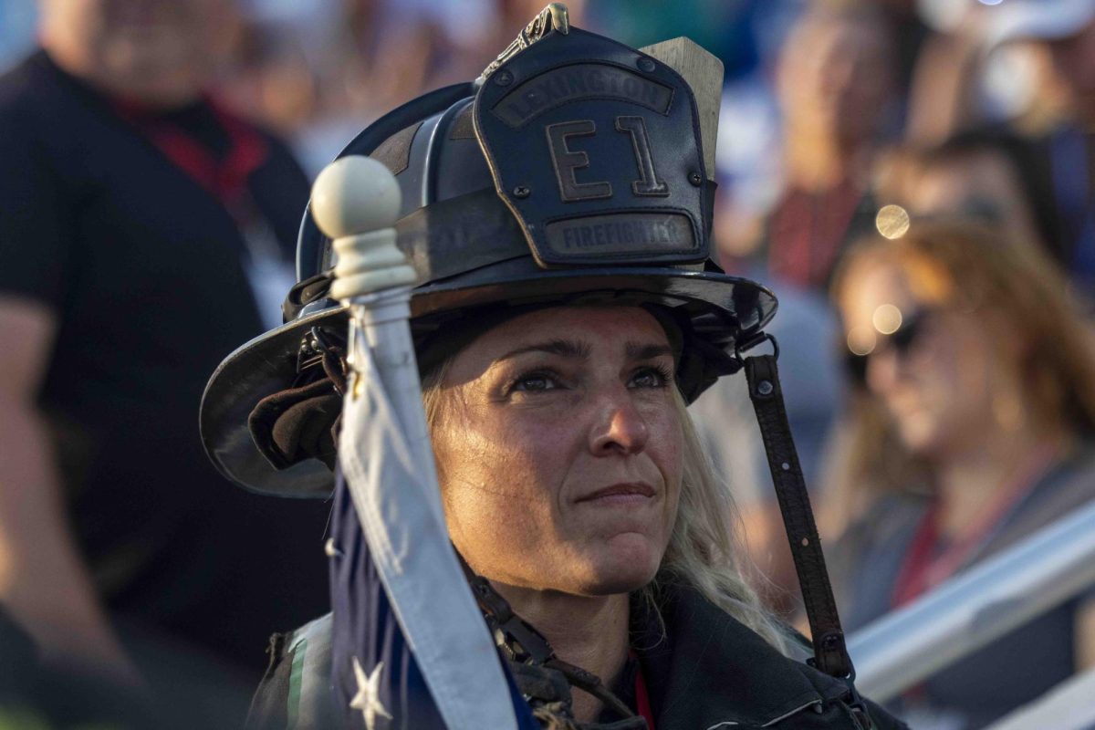 Firefighter Sara McGill holds and American flag during the 9/11 Memorial Stair Climb on Wednesday, Sept. 11, 2024, at Kroger Field in Lexington, Kentucky. Photo by Matthew Mueller | Staff