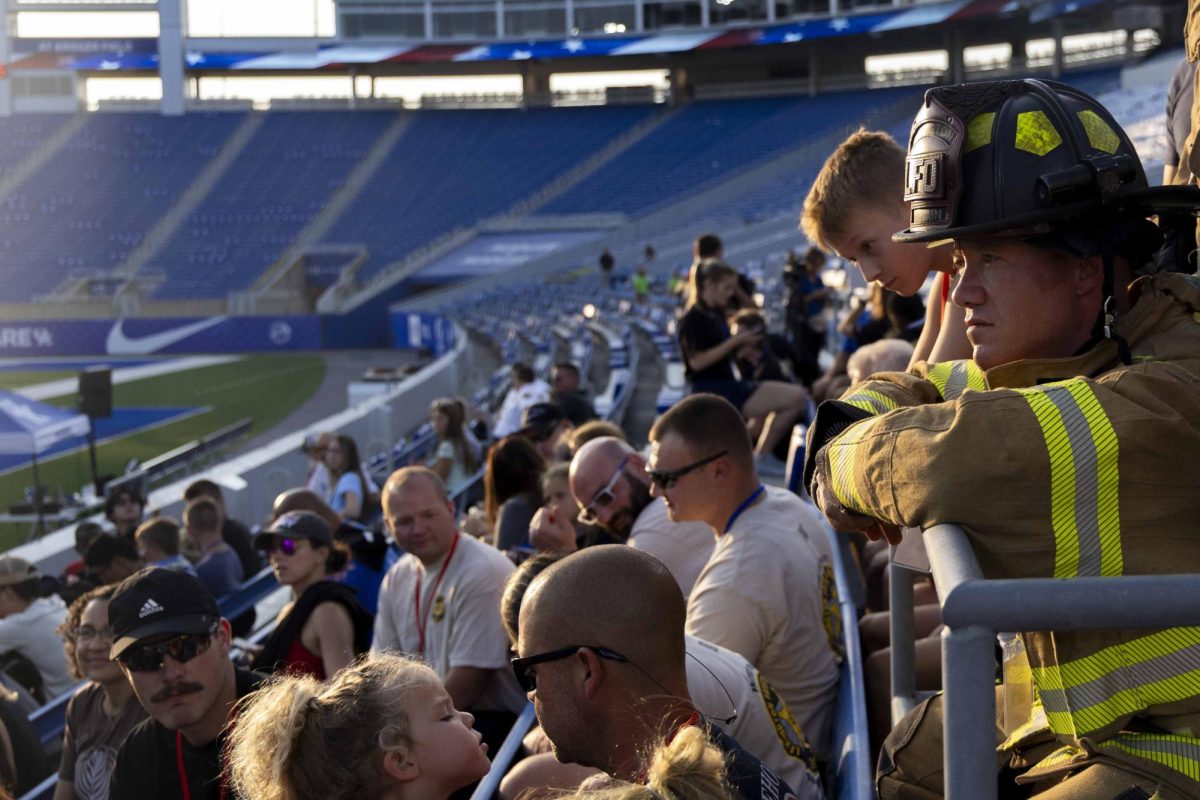 A firefighter leans on a rail before the 9/11 Memorial Stair Climb on Wednesday, Sept. 11, 2024, at Kroger Field in Lexington, Kentucky. Photo by Matthew Mueller | Staff