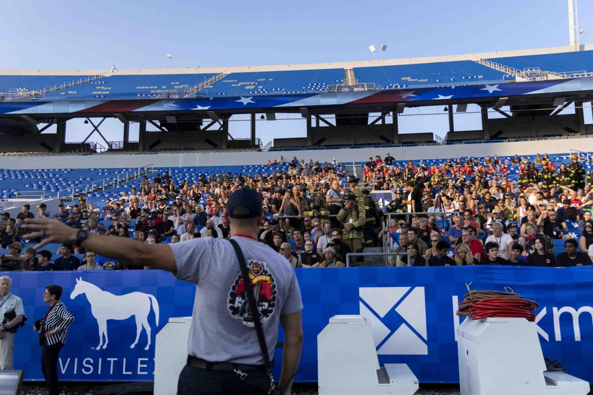 A firefighter instructs the participants on how this year’s stair climb will work before the 9/11 Memorial Stair Climb on Wednesday, Sept. 11, 2024, at Kroger Field in Lexington, Kentucky. Photo by Matthew Mueller | Staff