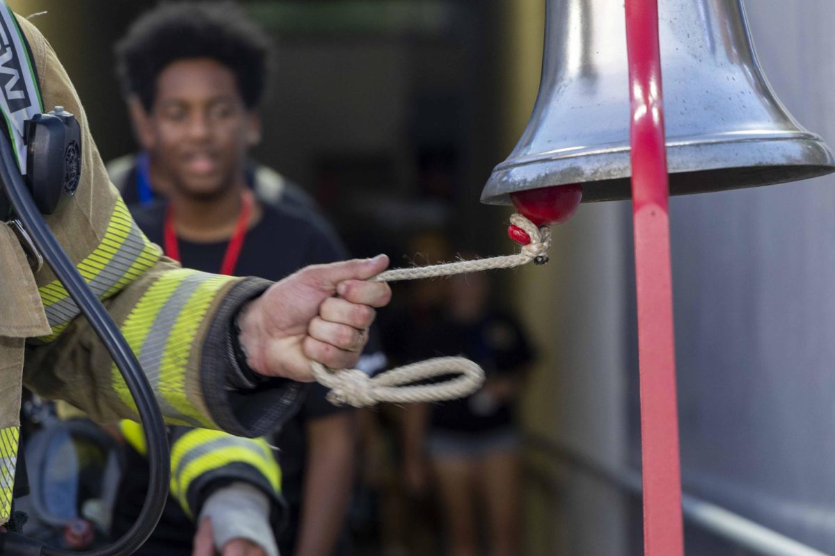 A firefighter rings a bell saying they’ve completed their first lap during the 9/11 Memorial Stair Climb on Wednesday, Sept. 11, 2024, at Kroger Field in Lexington, Kentucky. Photo by Matthew Mueller | Staff