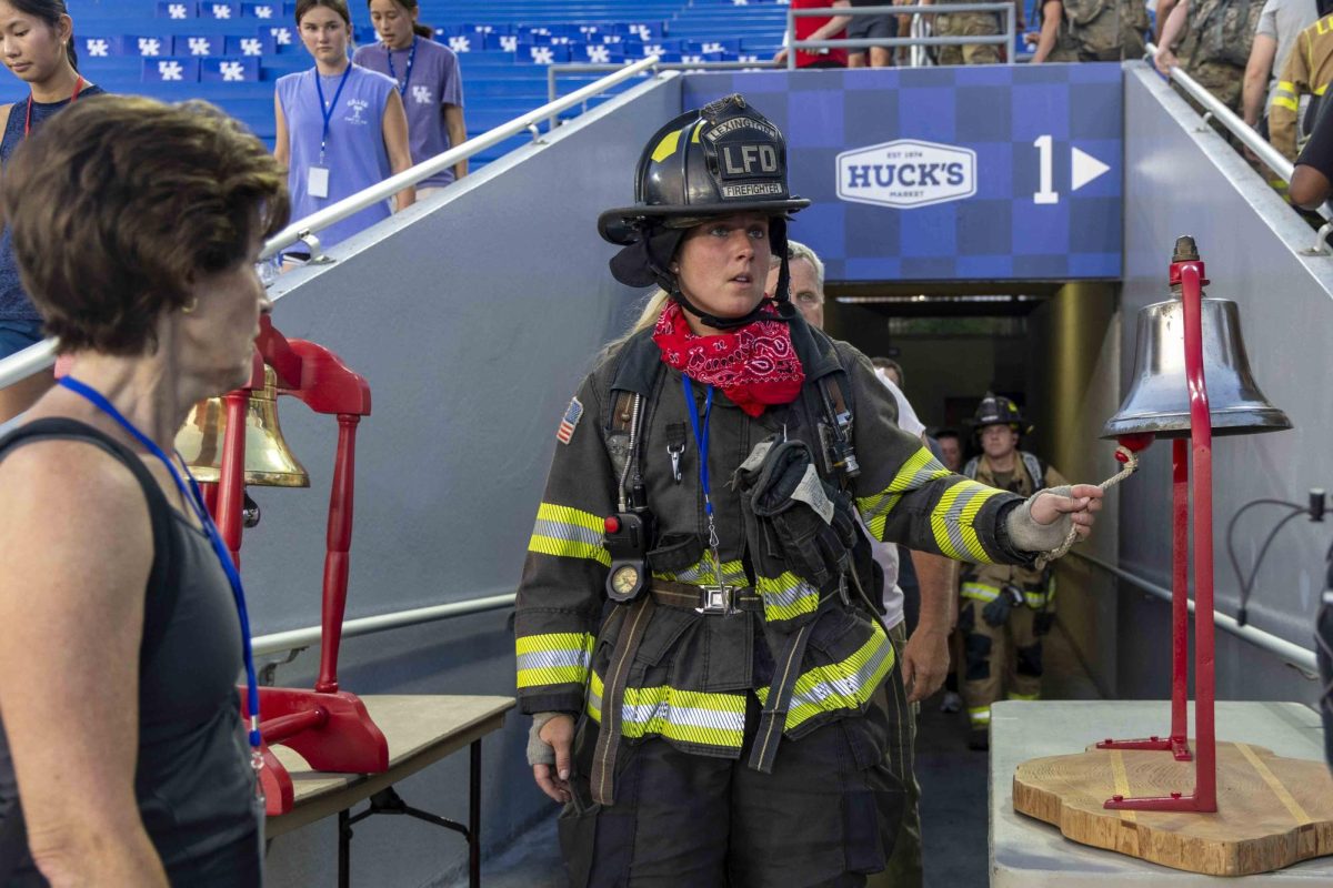 A firefighter rings a bell saying they’ve completed their first lap during the 9/11 Memorial Stair Climb on Wednesday, Sept. 11, 2024, at Kroger Field in Lexington, Kentucky. Photo by Matthew Mueller | Staff