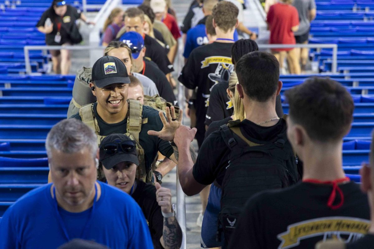 A participant high-fives other participants during the 9/11 Memorial Stair Climb on Wednesday, Sept. 11, 2024, at Kroger Field in Lexington, Kentucky. Photo by Matthew Mueller | Staff