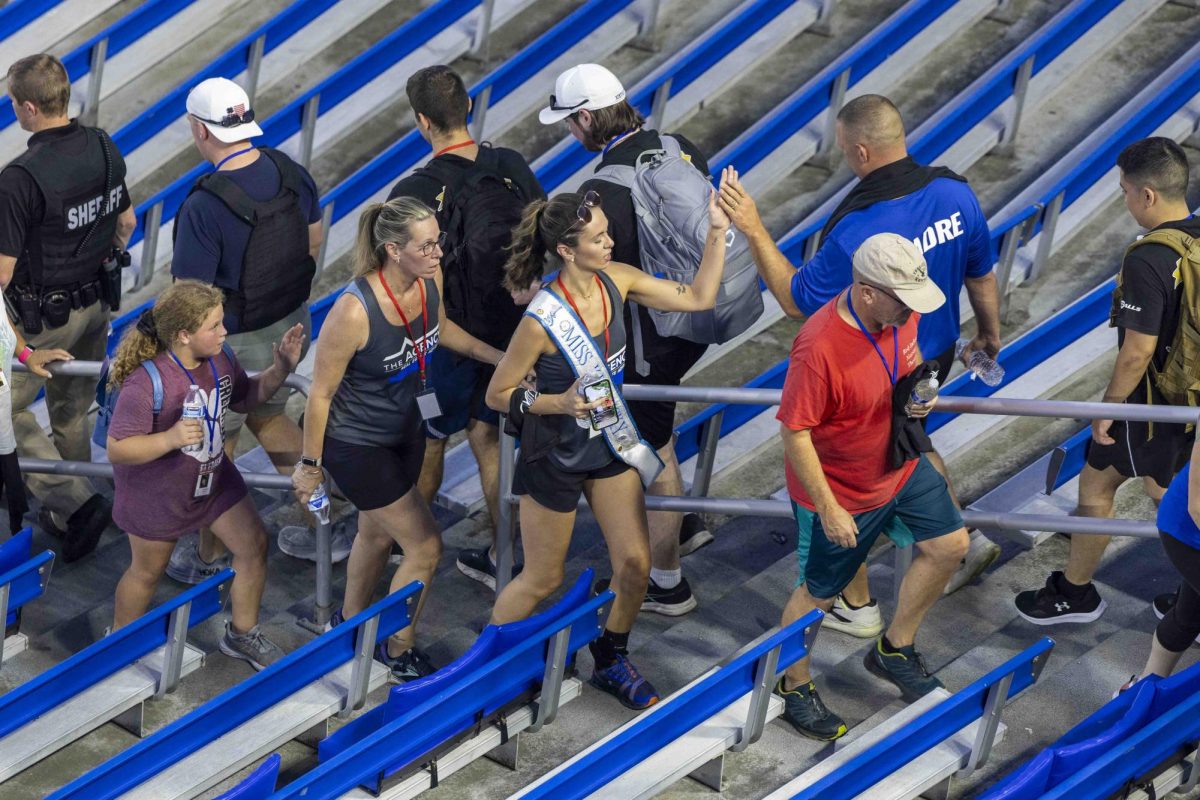 Miss Kentucky high-fives participants during the 9/11 Memorial Stair Climb on Wednesday, Sept. 11, 2024, at Kroger Field in Lexington, Kentucky. Photo by Matthew Mueller | Staff