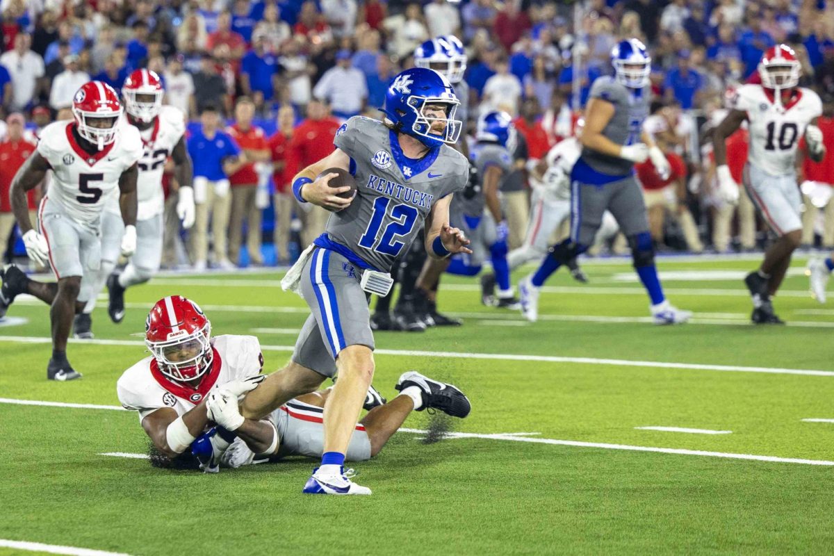 Kentucky Wildcats quarterback Brock Vandagriff (12) breaks a tackle from a defender during the game between Kentucky and Georgia on Saturday, Sept. 14, 2024, at Kroger Field in Lexington, Kentucky. Kentucky lost to Georgia 13-12. Photo by Matthew Mueller | Staff