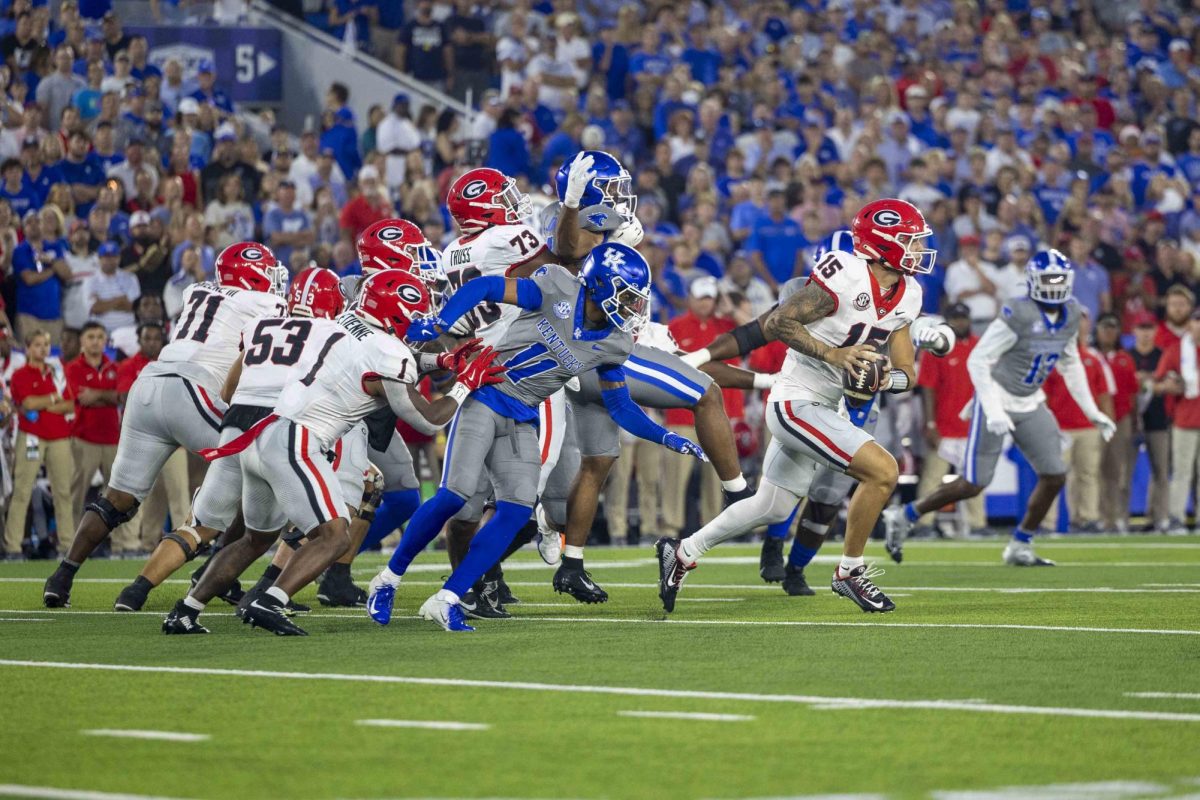 Georgia Bulldogs quarterback Carson Beck (15) scrambles past defenders during the game between Kentucky and Georgia on Saturday, Sept. 14, 2024, at Kroger Field in Lexington, Kentucky. Kentucky lost to Georgia 13-12. Photo by Matthew Mueller | Staff