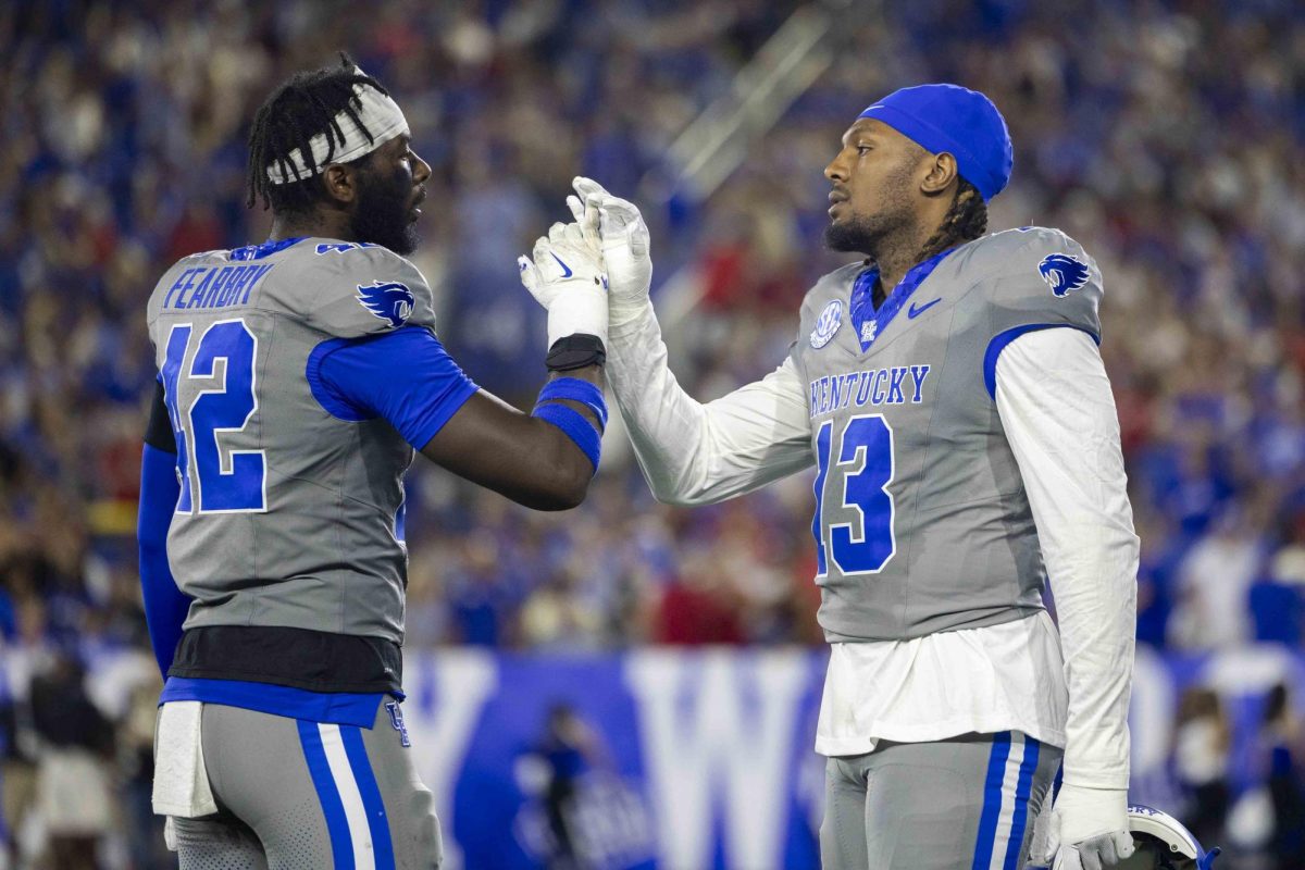 Kentucky Wildcats linebacker Tyreese Fearbry (42) and Kentucky Wildcats linebacker J.J. Weaver (13) meet at mid-field before the start of the second half during the game between Kentucky and Georgia on Saturday, Sept. 14, 2024, at Kroger Field in Lexington, Kentucky. Kentucky lost to Georgia 13-12. Photo by Matthew Mueller | Staff