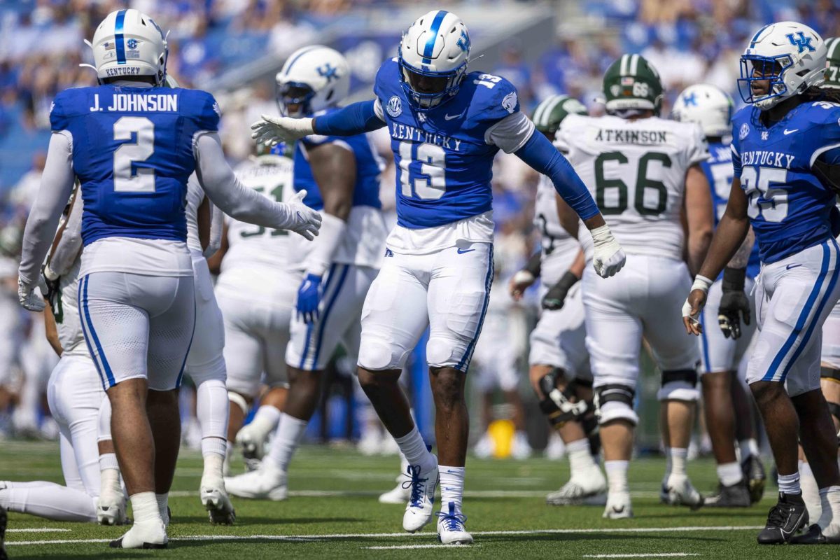 Kentucky Wildcats linebacker J.J. Weaver (13) high-fives Kentucky Wildcats linebacker Jamon Dumas-Johnson (2) after making a tackle for loss during the game vs. Ohio University on Saturday, Sept. 21, 2024, at Kroger Field in Lexington, Kentucky. Kentucky won 41-6. Photo by Matthew Mueller | Staff