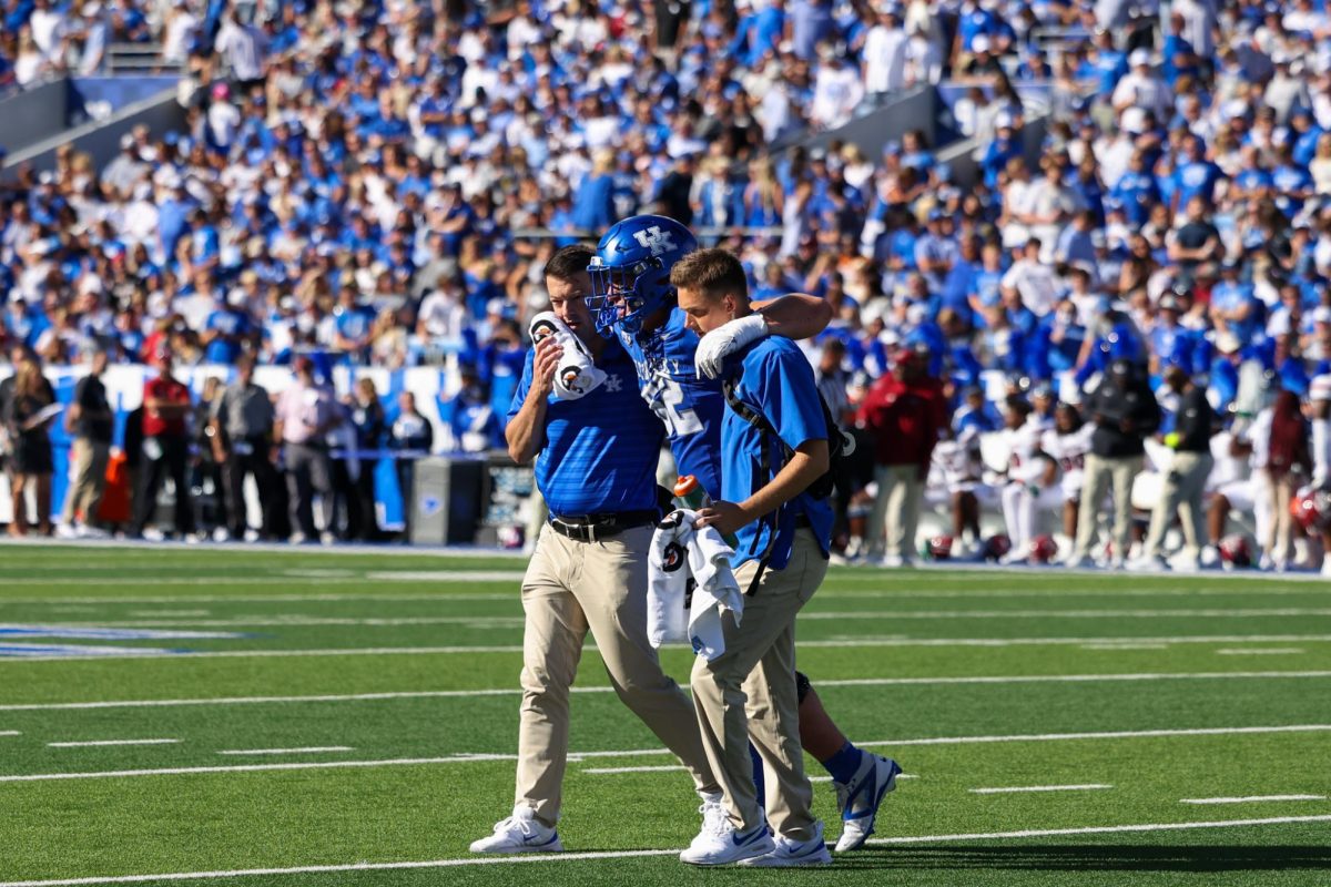 Kentucky offensive lineman Jager Burton walk off the field with help during the Kentucky vs Southern Carolina football game on Saturday, Sept. 7, 2024, at Kroger Field in Lexington Kentucky. Kentucky lost 31-6. Photo by Sydney Yonker | Staff