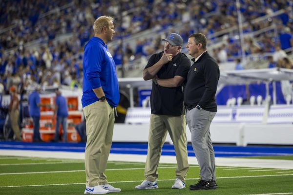 Kentucky Wildcats head coach Mark Stoops and Southern Miss Golden Eagles head coach Will Hall meet to discuss the game before the Kentucky vs Southern Mississippi football game on Saturday, Aug. 31, 2024, at Kroger Field in Lexington, Kentucky. Kentucky beat Southern Mississippi 31-0. Photo by Matthew Mueller | Photo Editor