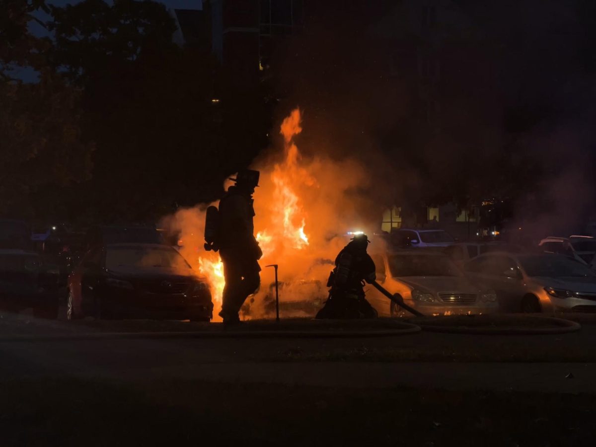 Firefighters put out a car fire on Thursday, Sept. 12, 2024, in the William T. Young Library parking lot in Lexington, Kentucky. Photo by Alexis Baker | Staff