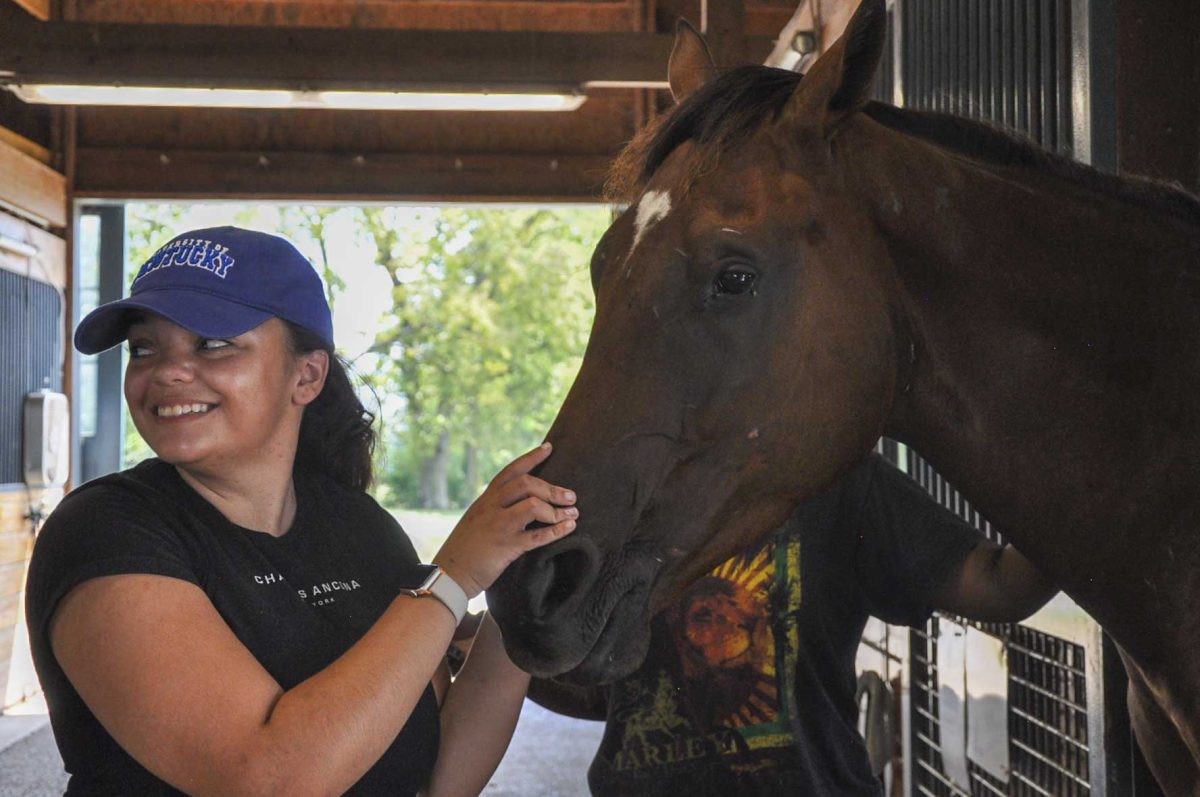 Sophomore Sydney Joiner pets a horse they are taking care of on Saturday, Aug. 31, 2024, at the Secretariat Center in Lexington, Kentucky. Photo by Isabella Sepahban | Staff