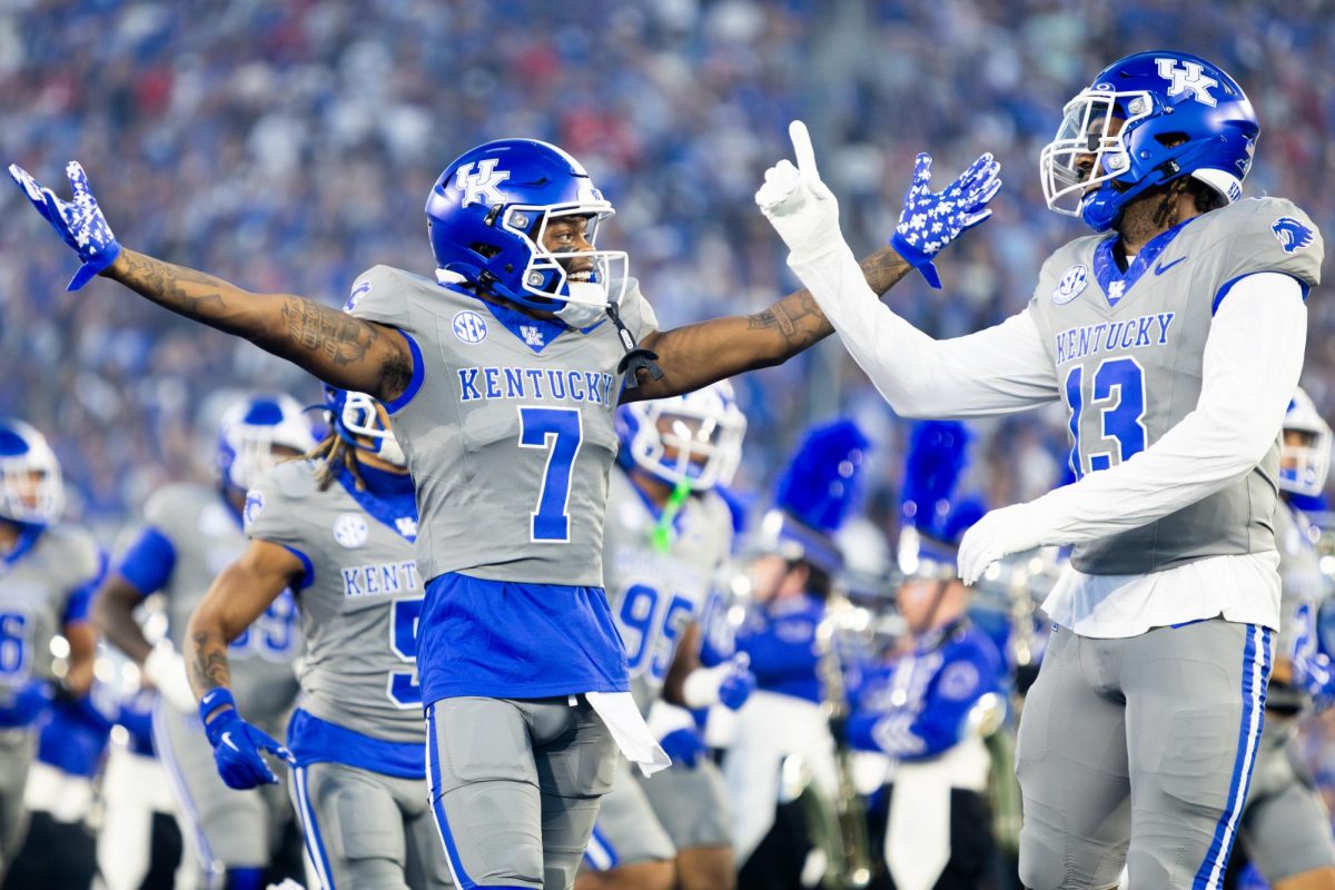 Kentucky wide receiver Barion Brown (7), left, and outside linebacker J.J. Weaver (13), run onto the field before the Kentucky vs. No. 1 Georgia football game on Saturday, Sept. 14, 2024, at Kroger Field in Lexington, Kentucky. Kentucky lost 13-12. Photo by Samuel Colmar | Staff