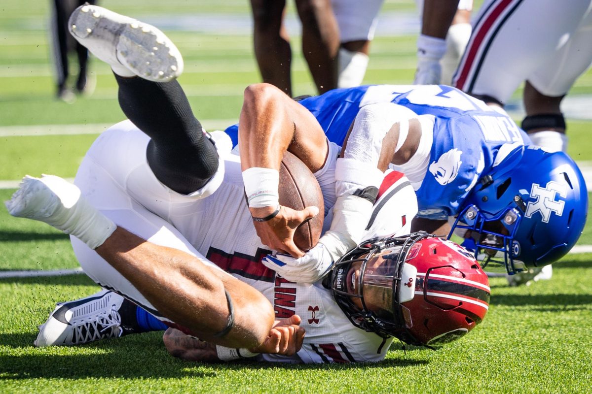 Kentucky outside linebacker Tyreese Fearbry (42) tackles South Carolina quarterback Robby Ashford (1) during the Kentucky vs. South Carolina football game on Saturday, Sept. 7, 2024, at Kroger Field in Lexington, Kentucky. Kentucky lost 31-6. Photo by Samuel Colmar | Staff