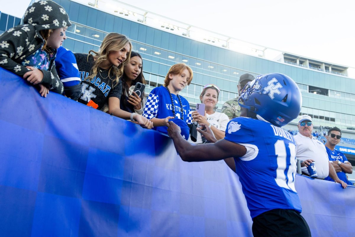 Kentucky defensive back Cam Dooley (18) signs a fans hat during the Kentucky vs. South Carolina football game on Saturday, Sept. 7, 2024, at Kroger Field in Lexington, Kentucky. Kentucky lost 31-6. Photo by Samuel Colmar | Staff