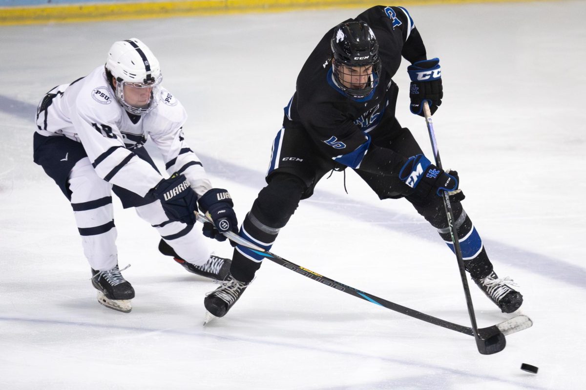 Kentucky defensemen Alex Kasapis (15) fights for the puck during the Kentucky vs. Penn State hockey match on Saturday, Sept. 14, 2024, at the Lexington Ice and Recreation Center in Lexington, Kentucky. Kentucky won 4-1. Photo by Samuel Colmar | Staff