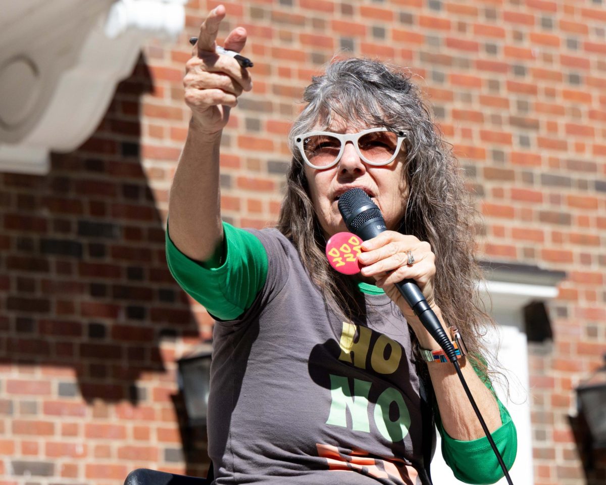 Cindy “Sister Cindy” Smock points at a student to give them a button during her sermon on Monday, Oct. 7, 2024, at the Memorial Hall outdoor amphitheater in Lexington, Kentucky. Photo by Christian Kantosky | Staff