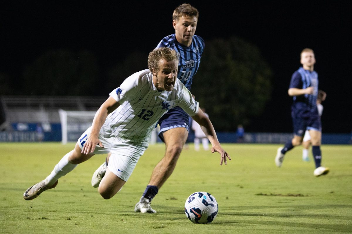 Forward Logan Dorsey is tackled by an Old Dominion defender in the Kentucky vs. Old Dominion soccer match on Friday, Oct. 11, 2024, at the Wendell and Vickie Bell Soccer Complex in Lexington, Kentucky. Kentucky won 1-0. Photo by Christian Kantosky | Staff