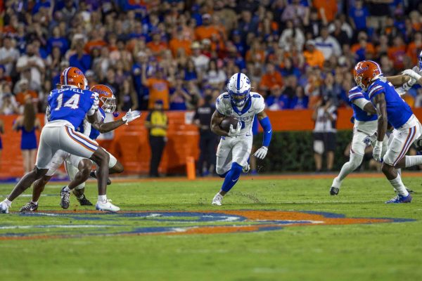 Kentucky Wildcats running back Demie Sumo-Karngbaye (0) runs through a gap in the defense during the football game vs Florida on Saturday, Oct. 19, 2024, at Ben Hill Griffin Stadium in Gainesville, Florida. Photo by Matthew Mueller | Staff