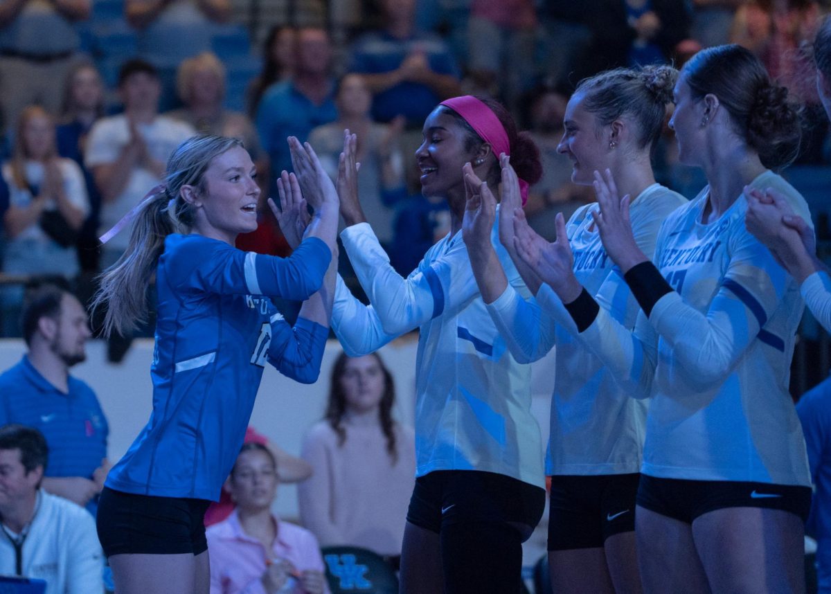 Kentucky libero Molly Tuozzo (12) runs onto the court welcomed by her teammates during the Kentucky vs Missouri Volleyball game on Sunday, Oct. 6, 2024, at Memorial Coliseum in Lexington, Kentucky. Kentucky won 3-0. Photo by Mateo Smith Villafranco | Staff