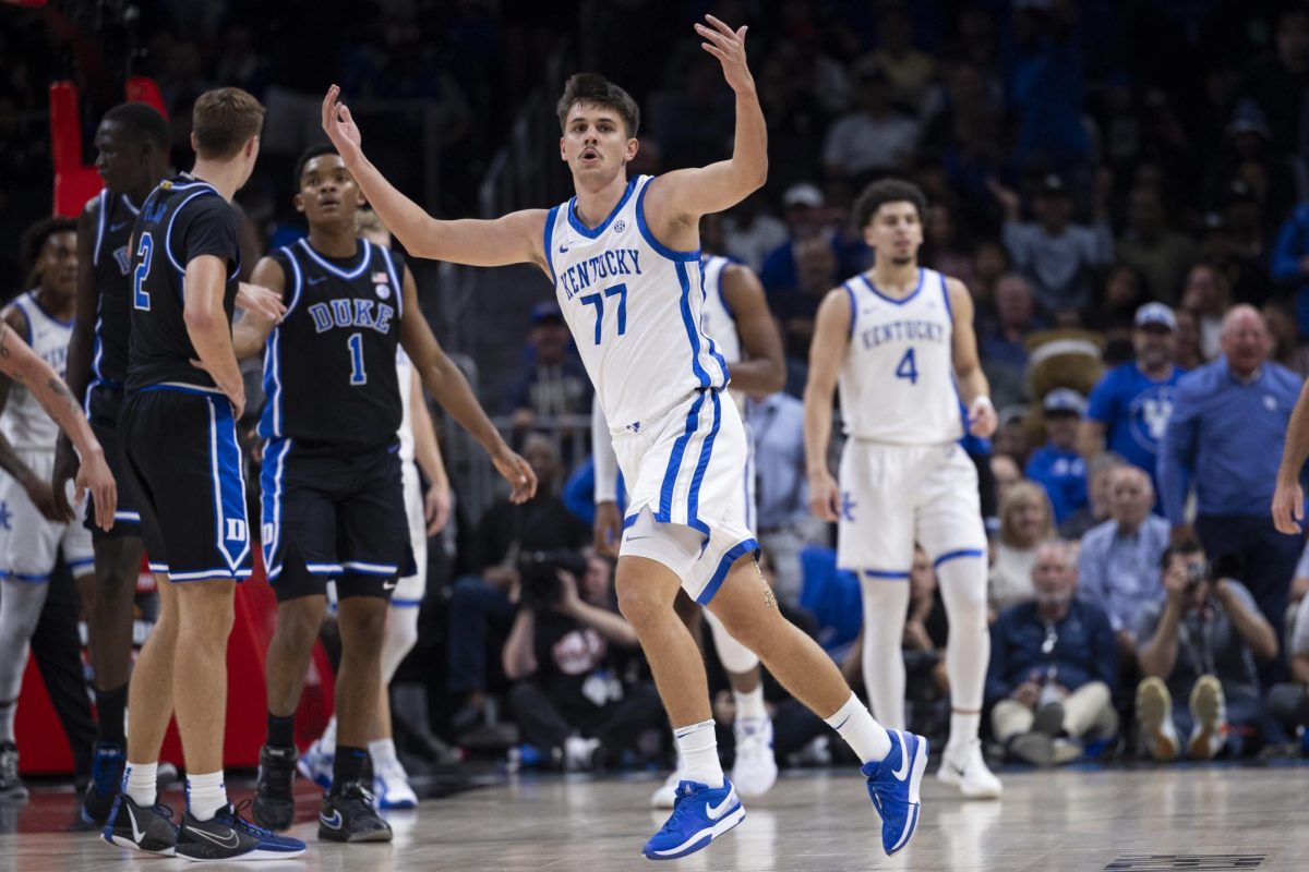 Kentucky Wildcats guard Kerr Kriisa (77) celebrates after drawing a charging foul during the basketball game vs. Duke on Tuesday, Nov. 12, 2024, at State Farm Arena  in Atlanta , Georgia . Kentucky won 77-72 Photo by Matthew Mueller | Photo Editor 