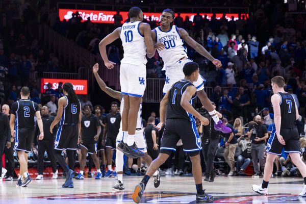 Kentucky Wildcats forward Brandon Garrison (10) and Kentucky Wildcats guard Otega Oweh (00) celebrate after defeating duke during the basketball game vs. Duke on Wednesday, Nov. 13, 2024, at State Farm Arena  in Atlanta , Georgia . Kentucky won 77-72 Photo by Matthew Mueller | Photo Editor 