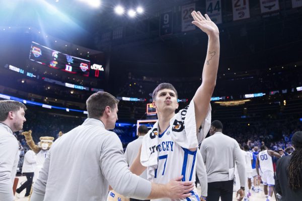 Kentucky Wildcats guard Kerr Kriisa (77) celebrates with fans during the basketball game vs. Duke on Wednesday, Nov. 13, 2024, at State Farm Arena  in Atlanta , Georgia . Kentucky won 77-72 Photo by Matthew Mueller | Photo Editor 