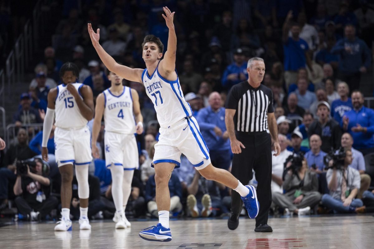 Kentucky Wildcats guard Kerr Kriisa (77) celebrates after drawing a charge during the basketball game vs. Duke on Tuesday, Nov. 12, 2024, at State farm Arena in Atlanta , Georgia . Photo by Matthew Mueller | Staff