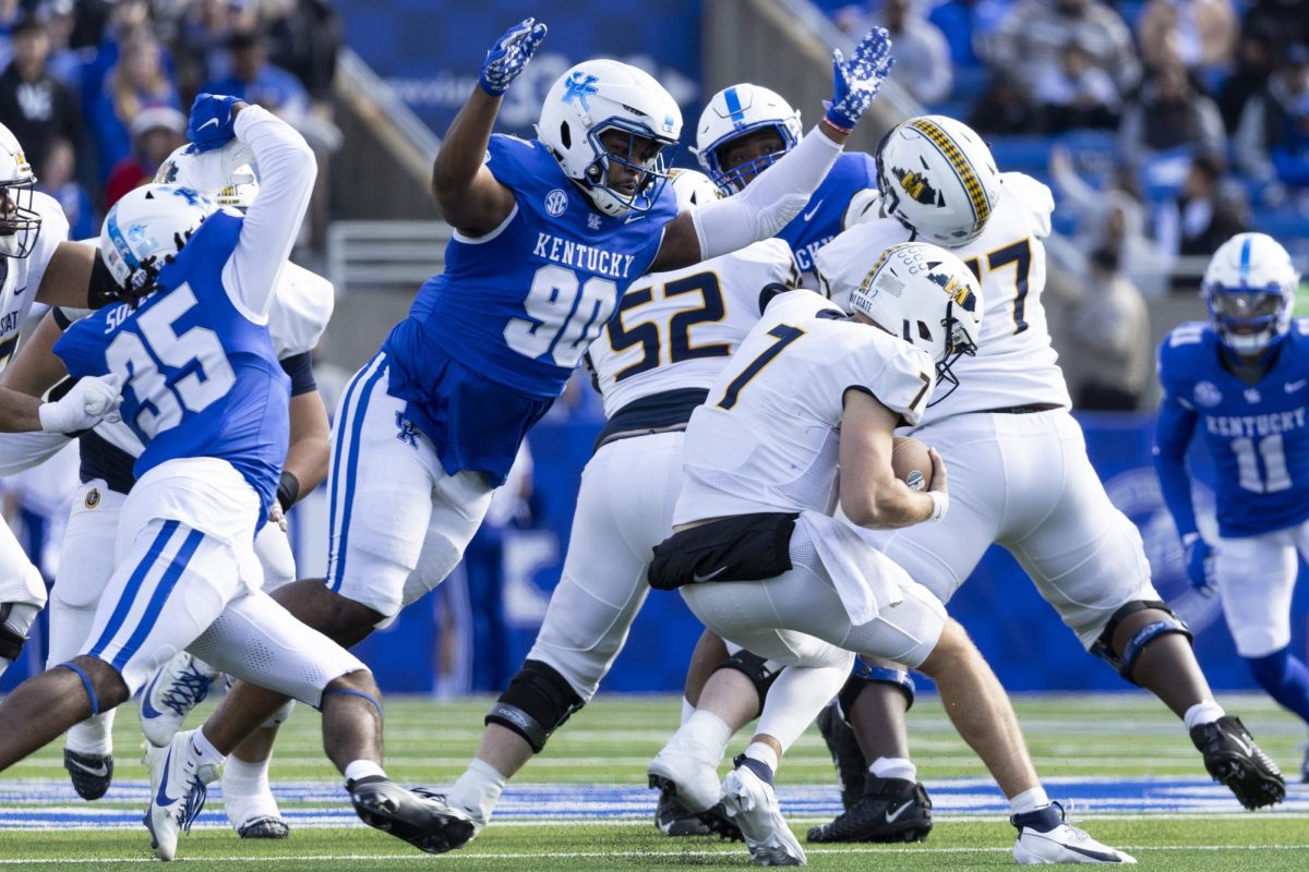 Kentucky Wildcats defensive lineman Tre'vonn Rybka (90) dives to sack Murray State Racers quarterback Jayden Johannsen (7) during the football game vs. Murray State Saturday, Nov. 16, 2024, at Kroger Field in Lexington, Kentucky. Photo by Matthew Mueller | Staff