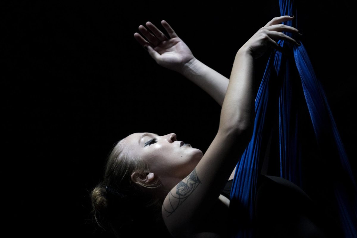 Emma Thyne poses while in the air during her performance of “The Swan” during the Circus Cats Falling into Winter showcase on Friday, Nov. 15, 2024, at Barker Hall in Lexington, Kentucky. Photo by Matthew Mueller | Photo Editor 