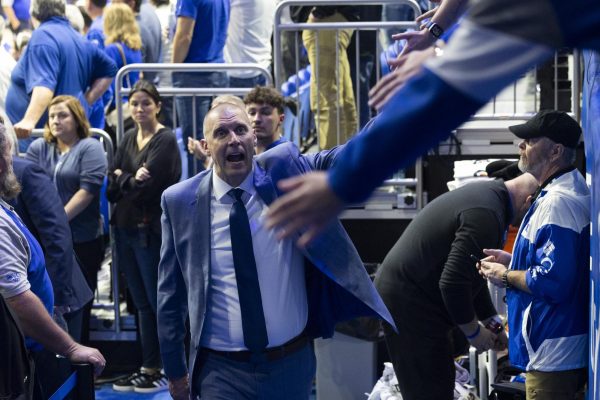 Kentucky Wildcats head coach Mark Pope high-fives fans after the basketball game vs. Lipscomb on  Tuesday, Nov. 19, 2024, at Rupp Arena in Lexington, Kentucky. Kentucky won 97-68. Photo by Matthew Mueller | Photo Editor