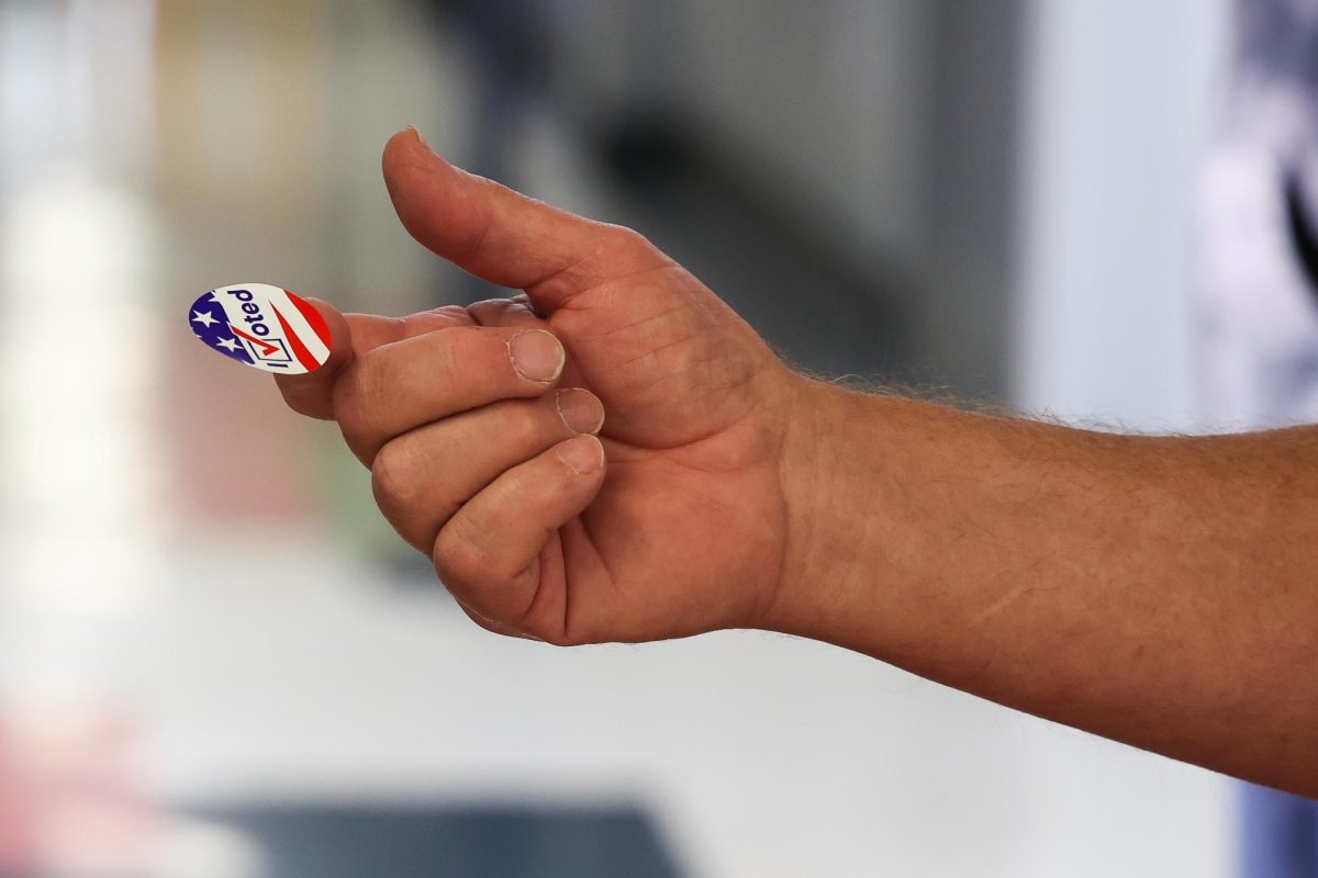 A poll worker holds an I Voted sticker on Election day on Tuesday, Nov. 5, 2024, at Maxwell Spanish Immersion Elementary School in Lexington, Kentucky. Photo by Abbey Cutrer