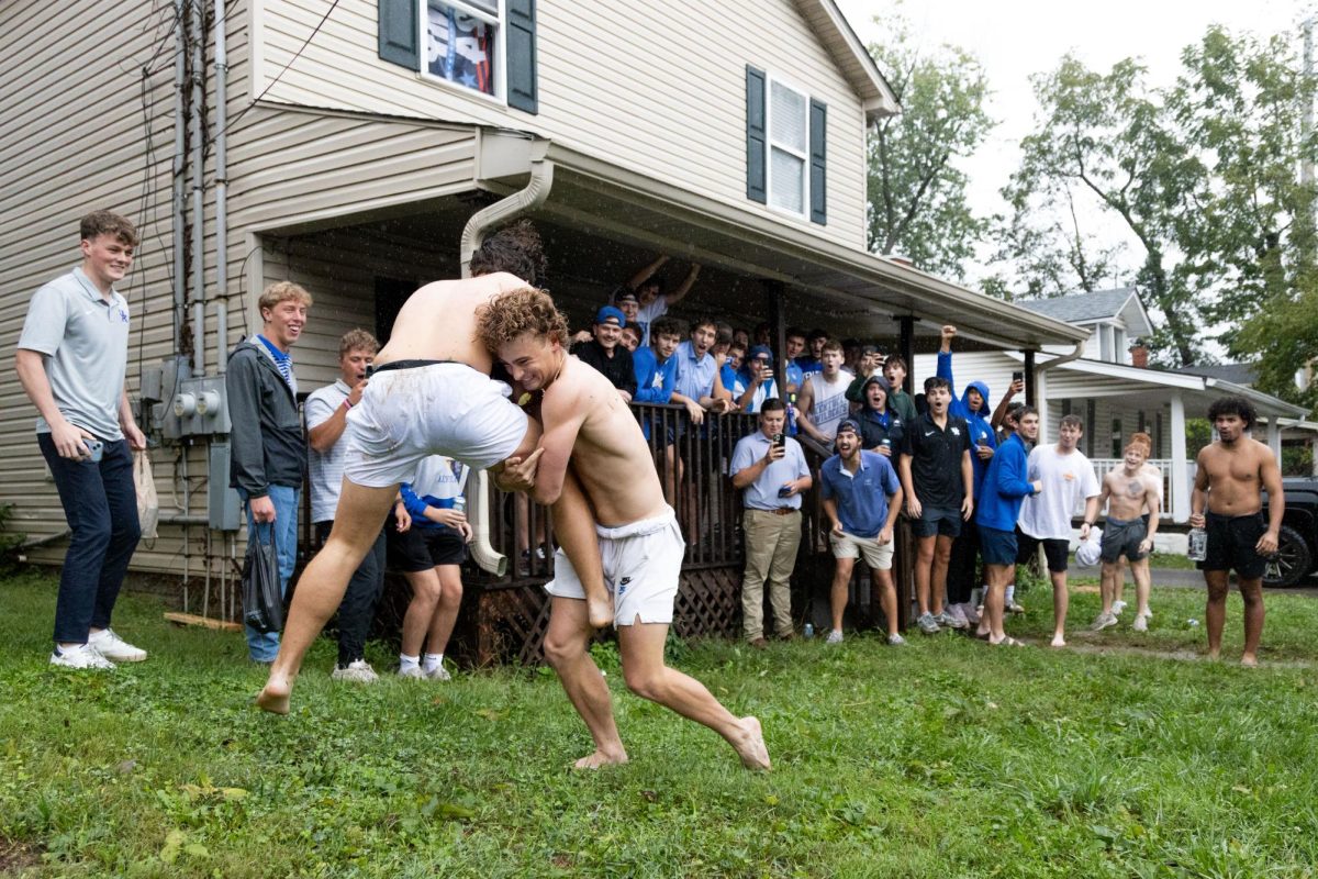 To celebrate Kentucky’s 20-17 win over Ole Miss, students play football, while others watch, on the front lawn of a house located on State Street on Saturday, Sept. 28, 2024, in Lexington, Kentucky. Photo by Christian Kantosky | Staff