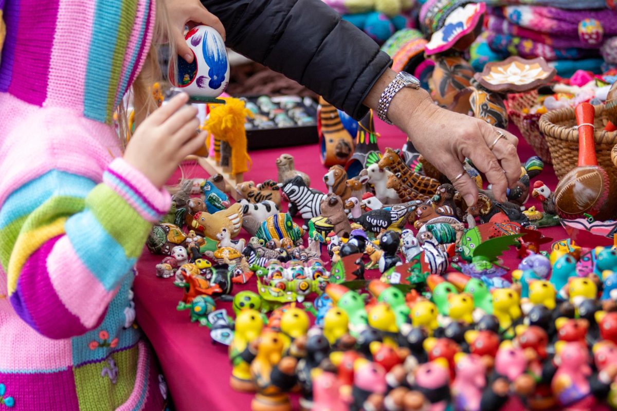 Grandmother Eileen Lindsay and her granddaughter look through handmade clay toys on Saturday, Nov. 9, 2024, at the Festival Latino de Lexington in Lexington, Kentucky. Photo by Sydney Novack | Staff