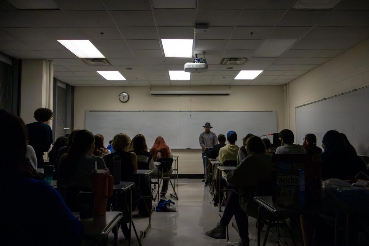 Trevor Wells, a senior history major speaks to the crowd at Sigma Tau Delta's Live Literature event in Room 201 - Chem-Phys Building at the University of Kentucky in Lexington, Kentucky, on Wednesday, Nov. 13, 2024. Photo by Sydney Novack | Staff