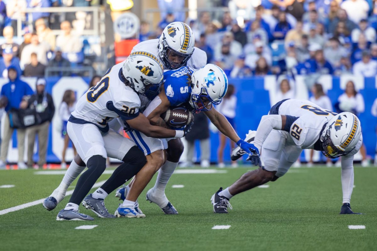 Kentucky Wildcats wide receiver Anthony Brown-Stephens (5) gets tackled by Murray State Defenders during the football game vs. Murray State on Sunday, Sept. 15, 2024, at Kroger Field in Lexington, Kentucky. Kentucky won 48-6. Photo by Sydney Novack | Staff