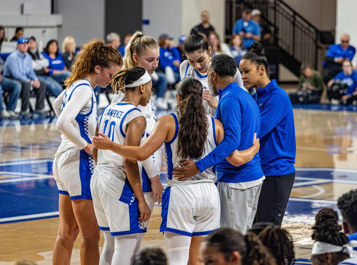 Kentucky Wildcats head coach, Kenny Brooks, and assistant head coach, Lindsey Hicks, huddle to discuss game strategy during the Kentucky vs. Louisville women's basketball game on Saturday, Nov. 16, 2024, at Historical Memorial Coliseum in Lexington, Kentucky. Kentucky won 71-61. Photo by Nathan Jones. | Staff