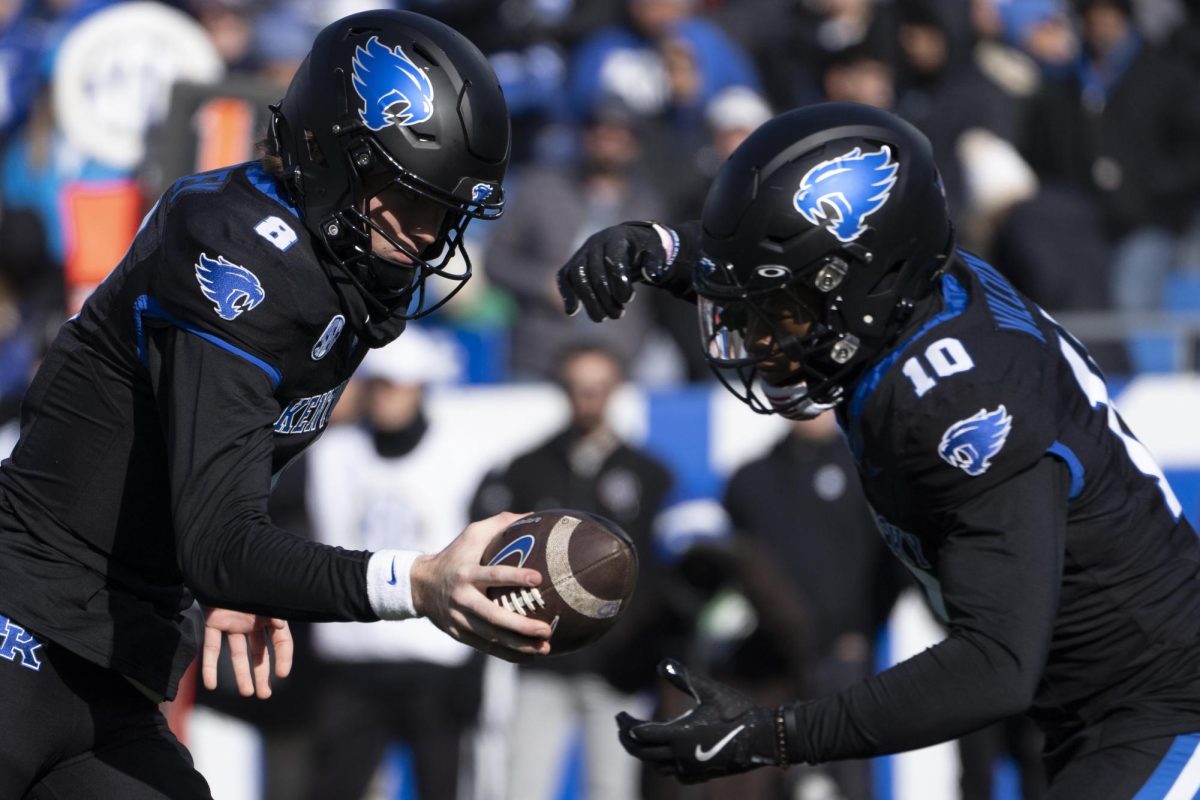 Kentucky Wildcats quarterback Cutter Boley (8) hands the ball off to Kentucky Wildcats running back Jamarion Wilcox (10) during the football game vs. Louisville on Saturday, Nov. 30, 2024, at Kroger Field in Lexington, Kentucky. Photo by Christian Kantosky | Assistant Photo Editor