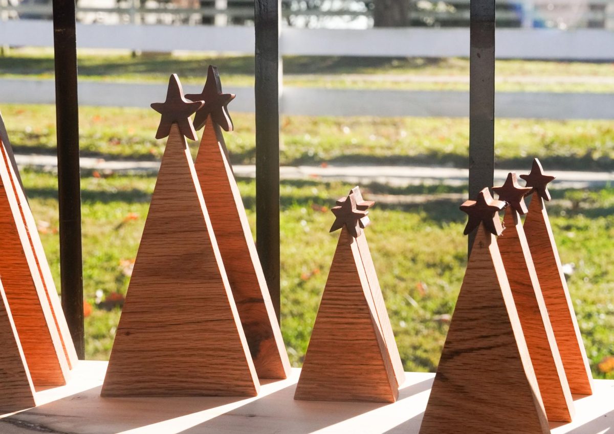 Wooden Christmas trees sit on a table for GandN Wood and Glass Creations at Shaker Village's Christmas Market on Nov. 16, 2024, in Harrodsburg, Kentucky. Photo by Hannah Piedad | Staff