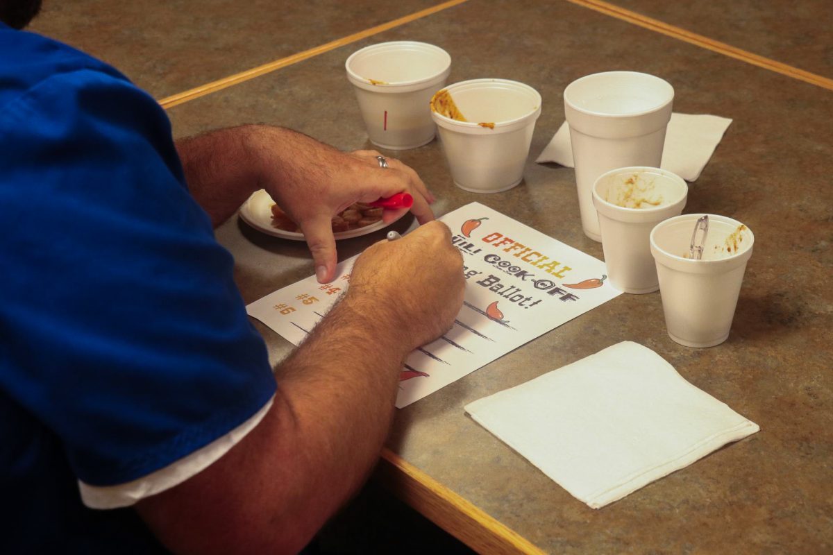 Chili cook-off judge and College of Nursing staff member Kenneth Powell fills out his voting ballot on October 24th, 2024. Photo by Michael Henning | Staff