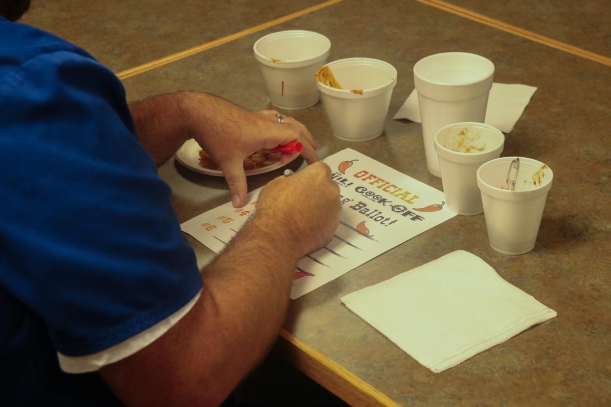 Chili cook-off judge and College of Nursing staff member Kenneth Powell fills out his voting ballot on October 24th, 2024. Photo by Michael Henning | Staff