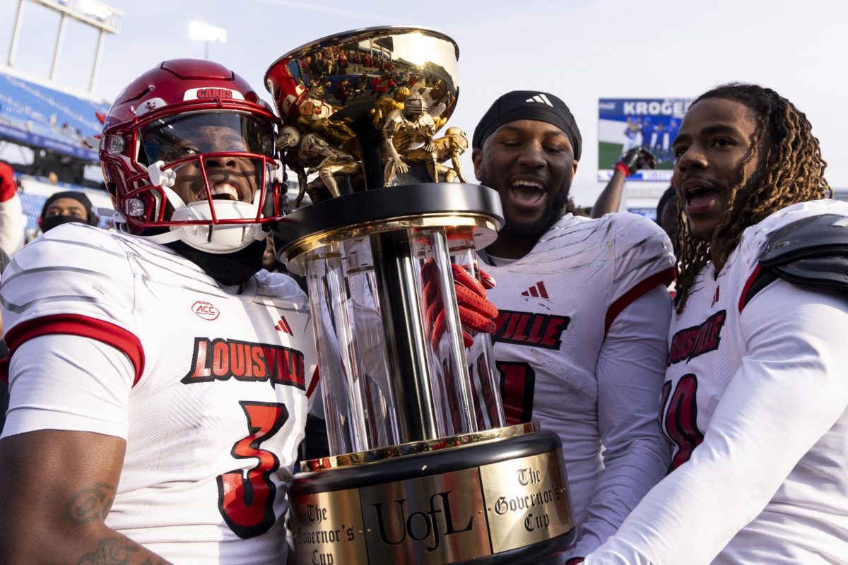 Louisville players celebrate while carrying the Governors Cup after the football game vs. Louisville on Saturday, Nov. 30, 2024, at Kroger Feild in Lexington, Kentucky. Kentucky lost 41-14. Photo by Matthew Mueller | Photo Editor