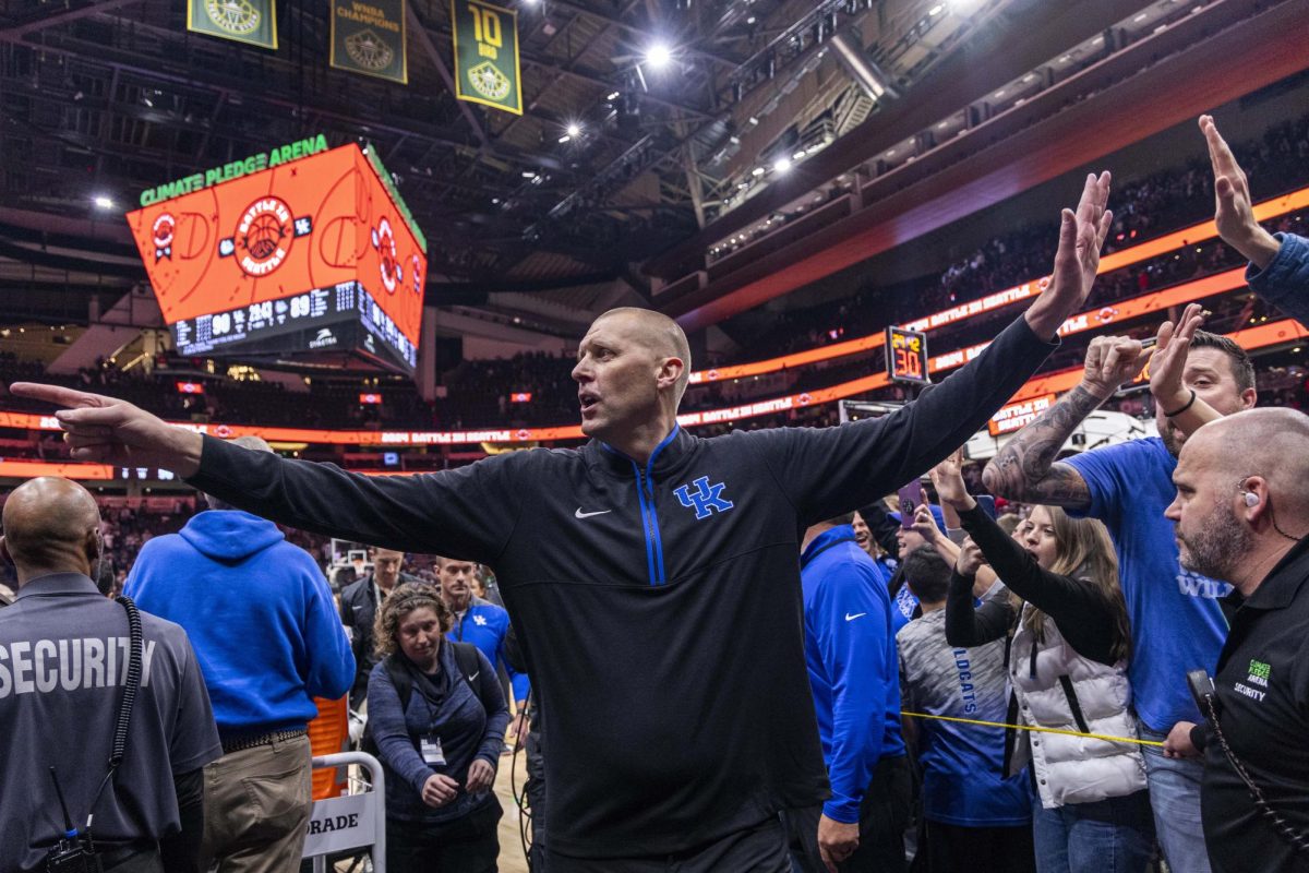 Kentucky Wildcats head coach Mark Pope high-fives fans after defeating the Gonzaga Bulldogs during the basketball game vs. Gonzaga on Sunday, Dec. 8, 2024, at Climate Pledge Arena in Seattle, Washington.  Kentucky won 90-89. Photo by Matthew Mueller | Photo Editor