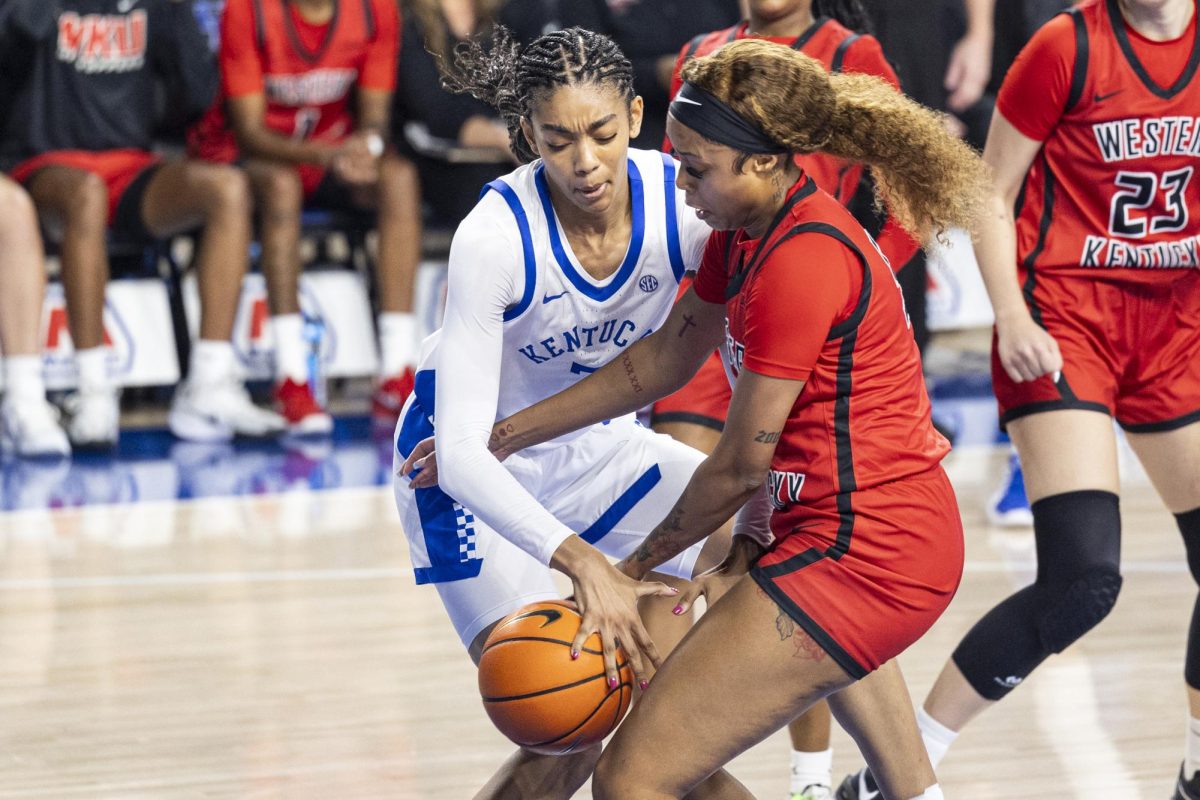 Kentucky Wildcats forward Teonni Key (7) fights for a loose ball with Western Kentucky Lady Toppers forward Mya Pratcher (5) during the basketball game vs. WUK on Saturday, Dec. 28, 2024, at Historic Memorial Coliseum in Lexington, Kentucky won 88-70 Photo by Matthew Mueller | Photo Editor